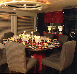 The elegant cherry wood formal dining area comfortably seats ten guests.